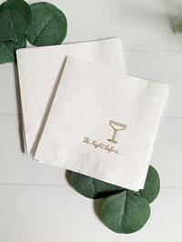 Add a touch of elegance to your rehearsal dinner with our "The Night Before" Elegant Cocktail Napkins. Each pack includes 16 white cocktail napkins, beautifully embellished with gold foil script that reads "the night before" paired with an elegant champagne coup glass icon. Measuring 4.75 inches, these napkins are perfect for setting the tone for your pre-wedding celebration.  Set of 16 Cocktail-Sized Rehearsal Dinner Napkins with Gold Foil. Whether you're toasting to love, sharing cherished moments with family and friends, or simply reveling in the anticipation of the big day, these napkins add a touch of sophistication and charm to your rehearsal dinner. Create lasting memories with "The Night Before" Elegant Cocktail Napkins, making your rehearsal dinner an unforgettable event filled wi