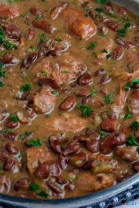 Red Beans and Rice - Red Beans cooked just right with smoked meat, and sausage – so creamy, perfectly tender, and so flavorful! Served with rice. RED