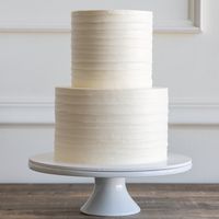 A simple buttercream cake with a dragged buttercream design, resembling the texture of tree bark. We suggest leaving your cake out at room temperature for at least 3 hours before serving to allow the buttercream to soften for optimal taste and texture.