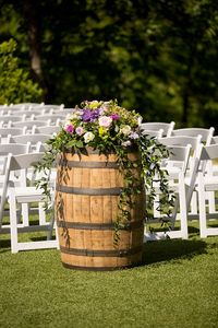 Seriously love this wine barrel as a piece of outdoor wedding decor! The amazing floral piece on top truly ties it all together. Perfect outdoor wedding decor for a rustic wedding! Taken at THE SPRINGS in Tulsa. Book your free tour today! Photographer: Redeemed Productions #rusticwedding #winebarrelweddingdecor #outdoorweddingdecor #rusticweddingdecor #rustic