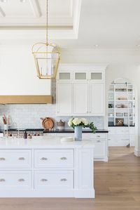 Kitchen with hood, arched pantry, gold pendants California Traditional Interior Design | Studio McGee Design Blog