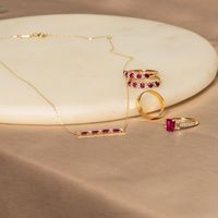 Add a pop of color with an alternating emerald cut ruby and round white sapphire bar necklace. Crafted from solid 10k yellow gold, it features 0.80 carats of emerald cut lab-created rubies and 0.23 carats of lab-created white sapphires.