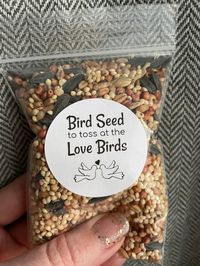 "Choose if you want Stickers ONLY or Stickers and Bags. No Bird Seed included. Assembly required. Stickers DO NOT come already attached to bags. Fill with your own Bird Seed, Dried Flowers, Wedding Confetti, Rice, petals etc.. and attach the stickers to bags yourself. DETAILS: -Stickers say \"Bird Seed to Toss at the Love Birds\" -Stickers are White Matte Circle labels 1.5 inch diameter and come on half sheets (not attached to clear bags). -Black Font wording color on white background. -Bags are