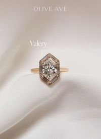 14K Yellow Gold | Valery features a stunning duchess shaped center stone with a halo made of baguette and round diamonds set in a cathedral setting on a half round flat edge shank.