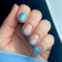 9. Frosty Blue Glitter French Tips with Snowflakes