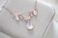 A delicate design with no shortage of sparkle, our simple rose gold cubic zirconia bridal necklace is crafted with Premium Cubic Zirconia stones. Handcrafted to perfection, you will want to wear this necklace long after your wedding day. - Created with Premium Cubic Zirconia stones- Rose gold finish- Available in rose gold, yellow gold, and rhodium finish.- Necklace measures 16 inches and extends to 18 inches- Pendant measures .8 inches x 2.5 inches- Nickel free and hypoallergenic- PLEASE ALLOW