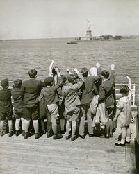 Jewish refugee children waving at the Statue of Liberty from the deck of the liner President Harding in 1939. Of 270,000 German Jews who applied for immigration visas, only 80,000 were allowed into the United States.