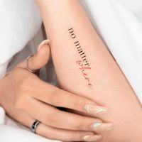 "No matter where" lettering tattoo placed on the wrist.