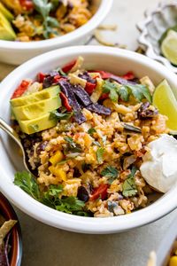 These Southwest Chicken Rice Bowls feature plenty of colorful veggies, chicken, rice, corn, cheese, black beans, and salsa.