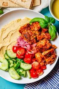 Chicken hummus bowls with tender chunks of chicken, creamy hummus, fresh veggies and a light, lemony vinaigrette are a healthy, hearty lunch or dinner.