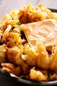 Blooming Onion with Dipping Sauce... This is such an incredible appetizer. The flavor of the battered onion combined with the sauce makes for one addictive and unforgettable recipe!