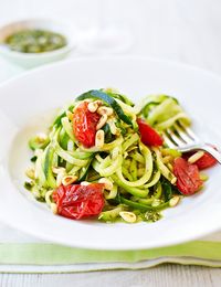 Who needs pasta when you can have spiralized courgette? Try our easy 'courgetti' recipe, made with baby plum tomatoes, garlic, pesto, pine nuts and a lot of courgette noodles