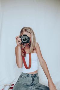 Blonde photographer holding camera portraits