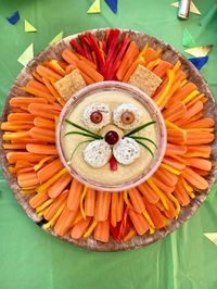 Looking for birthday party food for kids? How about this adorable lion dip?! Make this super easy and healthy vegetable tray with hummus and gluten-free bread that kids and adults are sure to love. Click to get the free recipe download and details. #wildone #firstbirthday #birthdayparty #firstbirthdayparty #easypartyideas #healthypartyfood #safariparty #kidsbirthday #lionking #lionkingparty