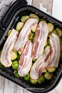 These air fryer brussel sprouts with bacon are a crispy and flavorful side dish. No need to fuss over this recipe. Just cut some brussel sprouts and toss them with some bacon, a little olive, and oil and then roast for a few minutes in the air fryer. Add some parmesan cheese or even a balsamic glaze for a slightly different flavor profile. #airfryerbrusselsproutswithbacon #airfrybrusselsproutswithbacon #baconbrusselsproutsintheairfryer #everythingairfryer