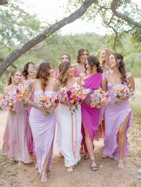 Bride and Bridesmaids in Pastel Lavender Dresses With Bright Bouquets