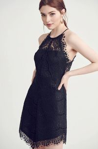 The Candice Black Lace Halter Mini Dress is simply effortless elegance! Black floral lace, over a matching knit lining, falls from a halter neckline, into a sleeveless bodice with button detail on back. Fitted waist sit above a full V-hem mini skirt.