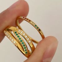 This split-shank gold ring features gracefully separated bands, creating a light, open feel. Accented with green and white stones, it’s a versatile piece perfect for daily wear or special moments.