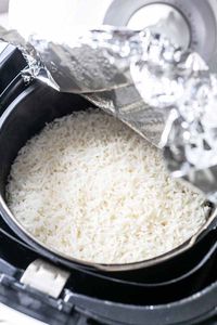 Yes, you can cook uncooked rice in an Air Fryer. It is really easy to get dry long grain rice in half an hour. Rice is the base for a lot of tasty side dishes like fried rice. Want to try? Visit fastfoodbistro.com for the full recipe and instructions