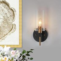 The clean and simple design with a plating brass and black finish adds a hint of glam to the modern luxury frame. This ambient wall sconce is ideal for entryways, hallways, bedrooms, dining rooms, or powder room task lights & bathroom vanity lights. Both for dry and damp locations. Install this wallchart with the lights pointing up or down to suit your tastes. Shade Shape: Cylinder | Longshore Tides Satilla 1 - Light Dimmable Black / Gold Armed Sconce Glass / Metal | 11 H x 5 W x 5.3 D in | Wayf