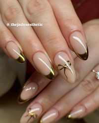 little golden bows & french tips, ✨🫶🏼 gel fill on natural nails w/ hand painted nail art <3 @stellar_gel - stellar bond - hard structure gel natural - stellar black - stellar matte top - stellar shine top @dndgel - dnd 871 how do u neutral? @the_gelbottle_inc - 2 in 1 base #chrometips #chromefrenchtips #goldfrenchtips #goldtips #goldbow #bownails #coquettenails #goldnails #goldchromenails #goldchrome #coquetteaesthetic #coquettefashion #nails #thenailawards #nailsnailsnails #nailsofin...