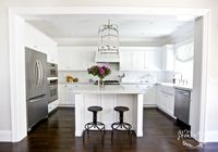 crisp white u-shaped kitchen + Carrera marble counters + lantern pendant