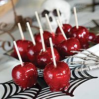 DIY Halloween Candy Apples..8 @Apples+Wooden Skewers, 2c Sugar, 1c Light Corn Syrup, 1/2c @Hot Water+Red Cinnamon Candies...Cover baking sheet w/foil+nonstick cooking spray. Remove apple stems+stick skewers firmly in stem end. Combine:water+corn syrup+sugar in saucepan over med-hi heat. Stir till sugar dissolves+continue to cook w/o stirring until mixture reaches 250*.Then add candies+stir together.Cook to 285*.Remove from heat+stir candy=smooth/even.Dip apple+place on sheet.Cool, rm temp, 24hr.