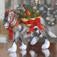 Breyer's 11th holiday horse is a dapple grey shire with feathers as white as freshly fallen snow. The silvery stars and red and gold tassels that bedeck his mane and tail glisten and the jingle of his Christmas bells proclaim his arrival. Clad in tartan harness, this gentle Shire carries on side a basket lined with greenery, filled with musical instruments, and laced with bows. usher in the joy of the season with Wintersong. Previsously offered in porcelain as Breyer's Drum Horse, Wintersong...