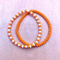 Ullabeads Orange and White Bead Bracelet | Orange Bead Bracelet Stack | Orange Bead Anklet | Halloween Bracelet ⚠️ NOTE: Please do NOT guess wrist size! Always measure your wrist :) ❤️ ★ Bead shades may vary slightly from picture (due to stock availability; screen resolution etc.)★ 🟠⚪️🟠⚪️🟠⚪️🟠⚪️ The color orange is associated with happiness, sunsets, energy, and vitality. These stretchy orange bracelets are great for any occasion and make a bold statement! Pair this set with your favorite outfit or footwear. Add these bracelets to your collection today! 🍊 📌OPTIONS A) Orange Bracelet  ONLY B) Orange and White Bracelet ONLY C) Set of both  📌 Details: * 4mm Seed Beads * Elastic Stretch Cord ⬇️ WANT MORE SEED BEADS? STACK 'EM ⬇️ ✨ Ullabeads Green and White Bracelet Set ✨ https://ullabead