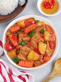 Pork Afritada with tender pork, carrots, potatoes, and bell peppers in rich tomato gravy is a dinner favorite for good reason! This pork stew is super easy to make and so tasty and filling. Perfect with steamed rice!