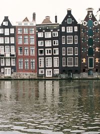 One of the most beautiful places in Europe - Amsterdam. Charming little canals, modern coffee shops and cafes, dutch flower style, boats. Must see and inspire for more travel ideas. What to do in Amsterdam? Just wander the little streets! | Yana Schicht | Signature print from analog film photography