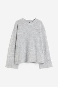 Soft  knit sweater with wool content. Crew neck  dropped shoulders  and long sleeves. Ribbing at neck  cuffs  and hem.