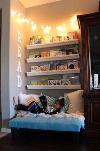 In order to create a budget-friendly reading nook for her kids in the family room, this clever mom repurposed rain gutters and end caps from Home Depot to make book shelves. Wooden letters from Michael's spell out "READ." Smart! See more at Vegas Mother Runner.