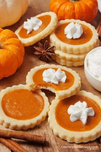 These adorable miniature pumpkin pie cookies are the perfect dessert for Thanksgiving and any fall gathering! Individual-sized and full of cozy flavors, they have everything you love about pumpkin pie and sugar cookies. These cookies come together quickly and are so much easier to prepare than a full-fledged pumpkin pie. The cookie crust adds a chewy, sweet texture to the rich, creamy filling. These mini pies are sure to become a new holiday tradition! | CountryHillCottage.com