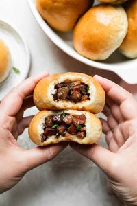 My family's Easy Baked Manapua (Hawaiian-Style Char Siu Bao) is the BEST! A char siu filling (made of Chinese-style BBQ pork, aromatics, & staples like oyster sauce & hoisin sauce) is stuffed into dinner roll dough from the freezer aisle (my family's secret ingredient for homemade manapua!) & baked until warm, puffy & golden brown. A true taste of Hawaii at home! #manapua #manapuarecipe #manapuarecipehawaii #charsiubao #bakedcharsiubao #charsiuporkbuns #porkbuns #hawaiianfood #localhawaiianfood