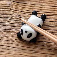 Small ceramic chopsticks rest representing a kawaii panda !   Size : 5.7cm(length) x 2.5cm(width)   It goes in the dishwasher.