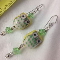 Handmade owl bead earrings with pastel yellow and green color palette #owl earrings #handmade #jewelry #earrings #pastel #beading #beadwork