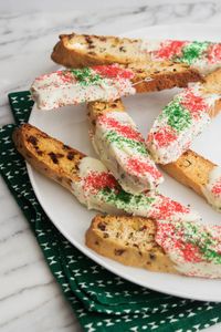 I love the color of these biscotti. You can actually make these year round with different colored sprinkles and dried fruit. The secret is the lemon zest which lightens the flavor of the biscotti and makes them truly unique.