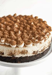 This Tiramisu Cheesecake recipe has a creamy coffee flavored filling with a white chocolate whipped topping and a dusting of cocoa powder.