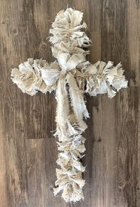 ✝️ Introducing the Exclusive Hand-Torn Canvas Rag Wreath, a unique piece of art that combines rustic charm with a touch of elegance. Unique and Meaningful: This wreath is not just decor; it's a statement of faith, resilience, and unyielding strength. The cross shape symbolizes your beliefs and values. Elegant and Modern: Each wreath is meticulously crafted by hand, tearing heavy duty canvas fabric to create a lush, textured appearance that's both visually appealing and tactile. Perfect for gracing your front door or accentuating your interior décor, this wreath adds a warm, welcoming touch to any space. The neutral tones seamlessly blend with various color palettes while the intricate textures invite guests to feel and admire. Durable yet delicate, this wreath is designed to be a lasting a