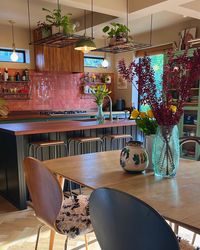 Flowers on dining table in newly renovated kitchen.