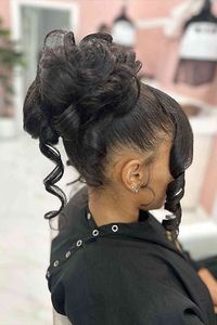 Create a stylish look with a high messy bun with front curls, effortlessly blending elegance and playfulness. Check out the 26 beautiful updos for black women to find more stunning hairstyles that will inspire you. // Photo Credit: Instagram @hairbyjazmeen