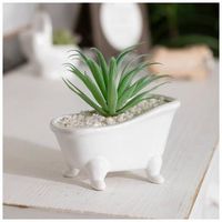 Dimensions: 6.2" H x 3.2" W x 6.1" D Material: Ceramic & Plastic Color: White & Green Quantity: 1 Fill your bathroom with fun faux florals like this Succulent In Bathtub Pot. This humorous piece features a tall, flocked green succulent planted in a ceramic white bathtub. The plant sprouts up from a bed of white pebbles to tie the look together. Place this piece in your bathroom and pair it with other plant-themed decor for a relaxing aesthetic!