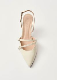 Cream patent leather pointed-toe slingback heels  Set atop slender heels and made from cream patent leather, the Joelle pumps are synonymous with elegance. They’re shaped to a pointed toe defined by slim straps with gold buckles lying across the vamp.