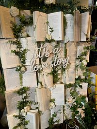 Thrifted books, dollar store flowers, twinkle lights and a “its a love story” light up sign a perfect DIY for a budget brides!