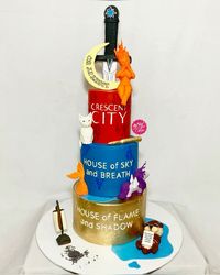 Tribute cake to the Crescent City books including House of Earth and Blood (HOEAB), House of Sky and Breath (HOSAB) and House of Flame and Shadow (HOFAS)