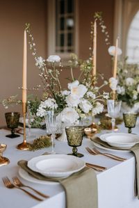 Elegant white & green wedding tablescape. White & green florals mixed with green glassware, rose gold cutlery and simple white plates. Find my most recent work on Instagram @meredithlord