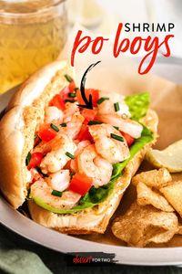 Close up of shrimp po boy sandwich with chips.