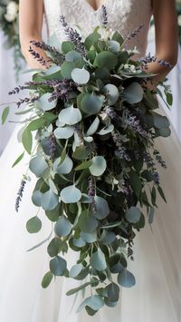 Create a stunning lavender and eucalyptus cascade bouquet for your big day! Add a touch of movement and drama with flowing eucalyptus leaves paired with lavender sprigs. Perfect for garden or rustic weddings. Check out similar ideas now!