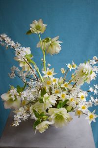 A stunning white wedding centerpiece with locally grown botanical treasures for a spring wedding.